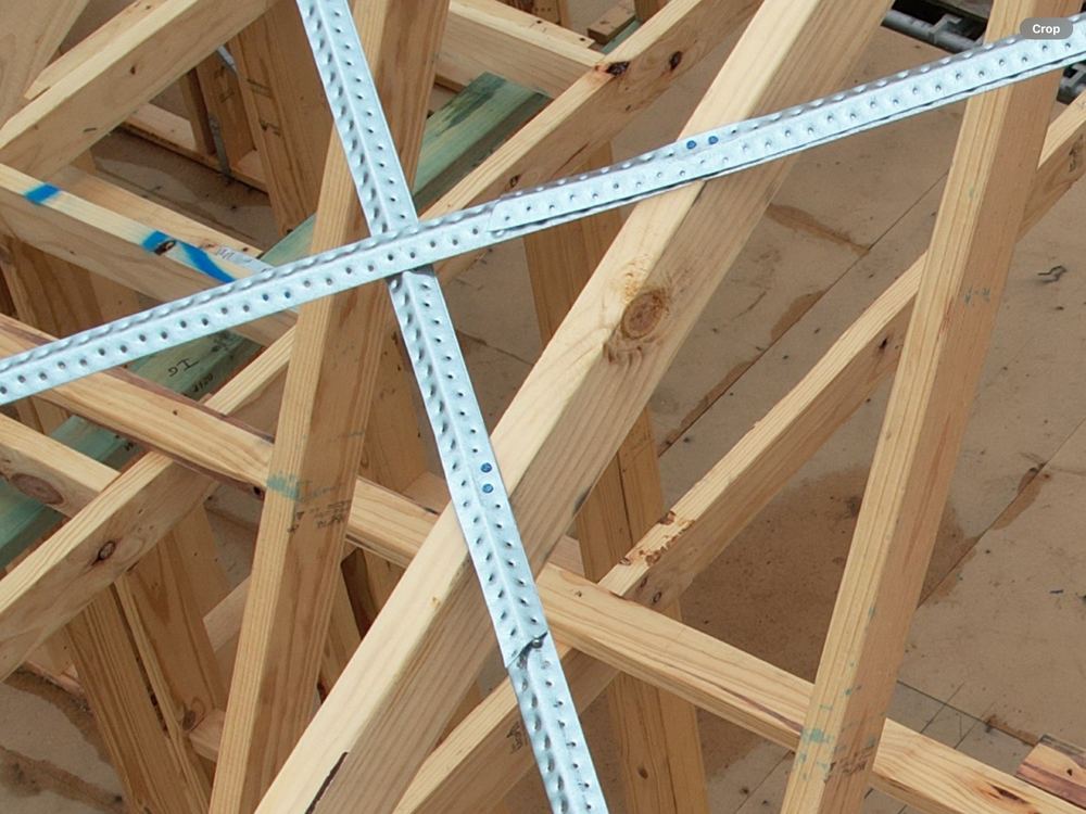 Roof brace joined with a short overlap and too few fixings at each end, found during a frame inspection in Berwick
