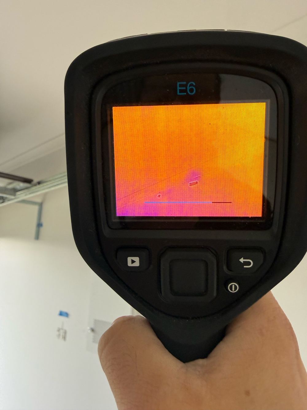 Thermal camera tracing damp behind mould on a garage ceiling, found during a defect investigation in Berwick