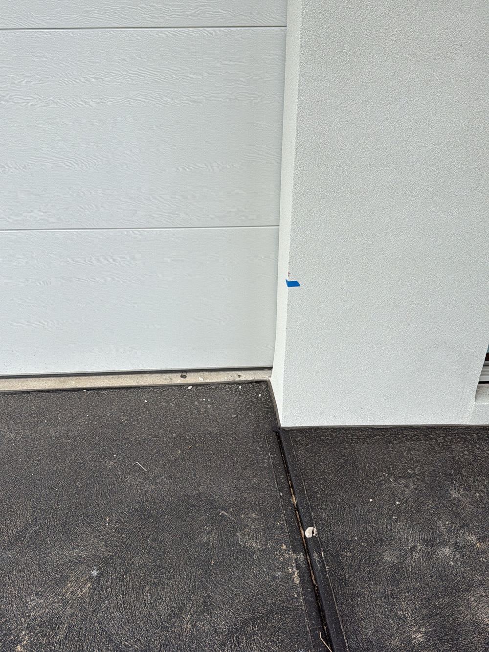 Garage wall leaning out of plumb past the allowed limit, found during a pre-handover inspection in Berwick