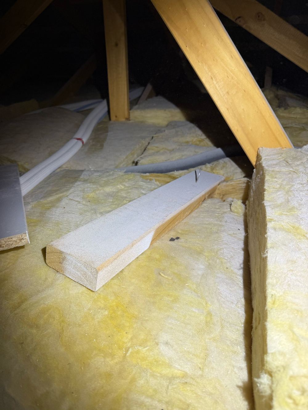 Loose timber with a nail sticking out, left behind in the roof space, found during a pre-handover inspection in Berwick