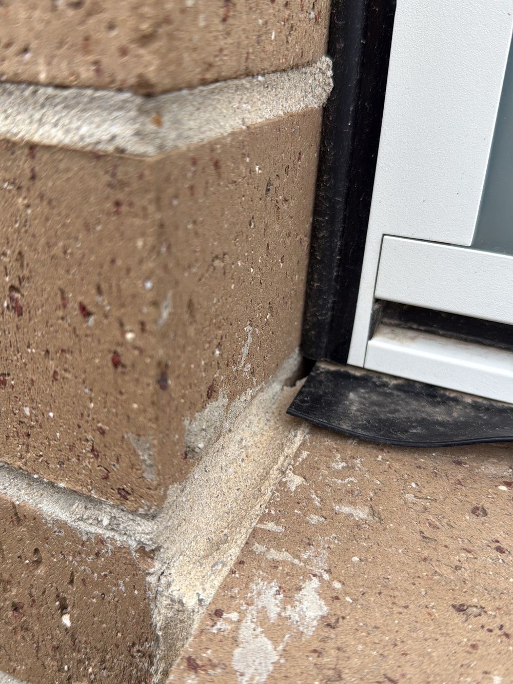 Gaps between brick sills and window frames where rain can get in, found during a pre-handover inspection in Berwick