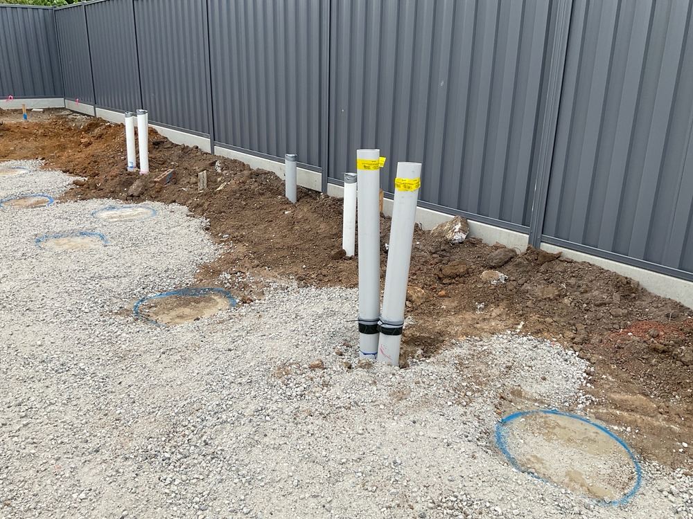Waste risers leaning out of plumb, pointing to poor setting or damage below, found during a bored pier inspection in Berwick