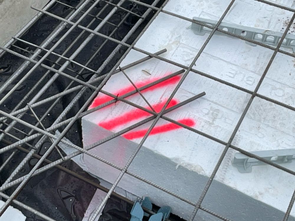 Reinforcement resting low because bar chairs were missing beneath it, found during a slab pre-pour inspection in Berwick