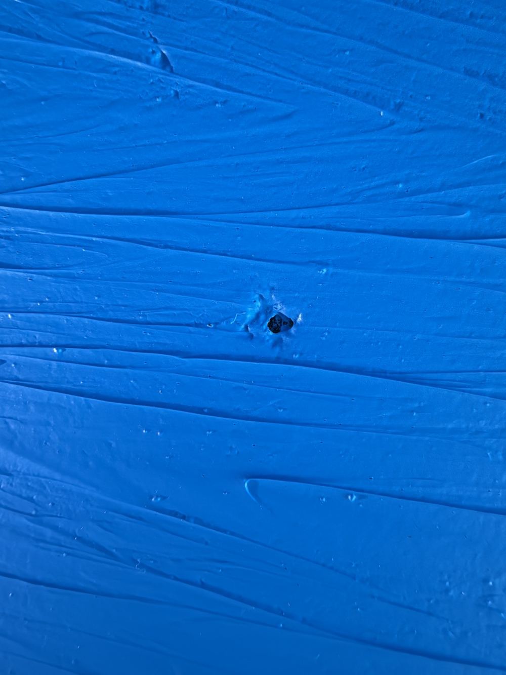 Shower base membrane with what looks like a puncture through it, found during a waterproofing inspection in Berwick